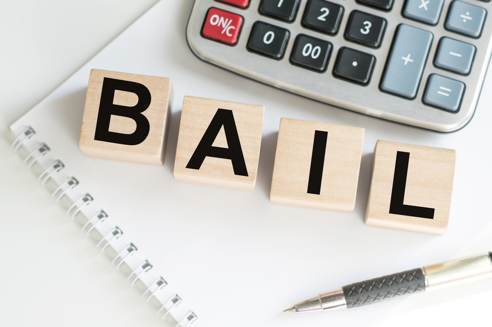 Word,Bail,On,Wooden,Cubes,On,Blue,Background.,The,Inscription